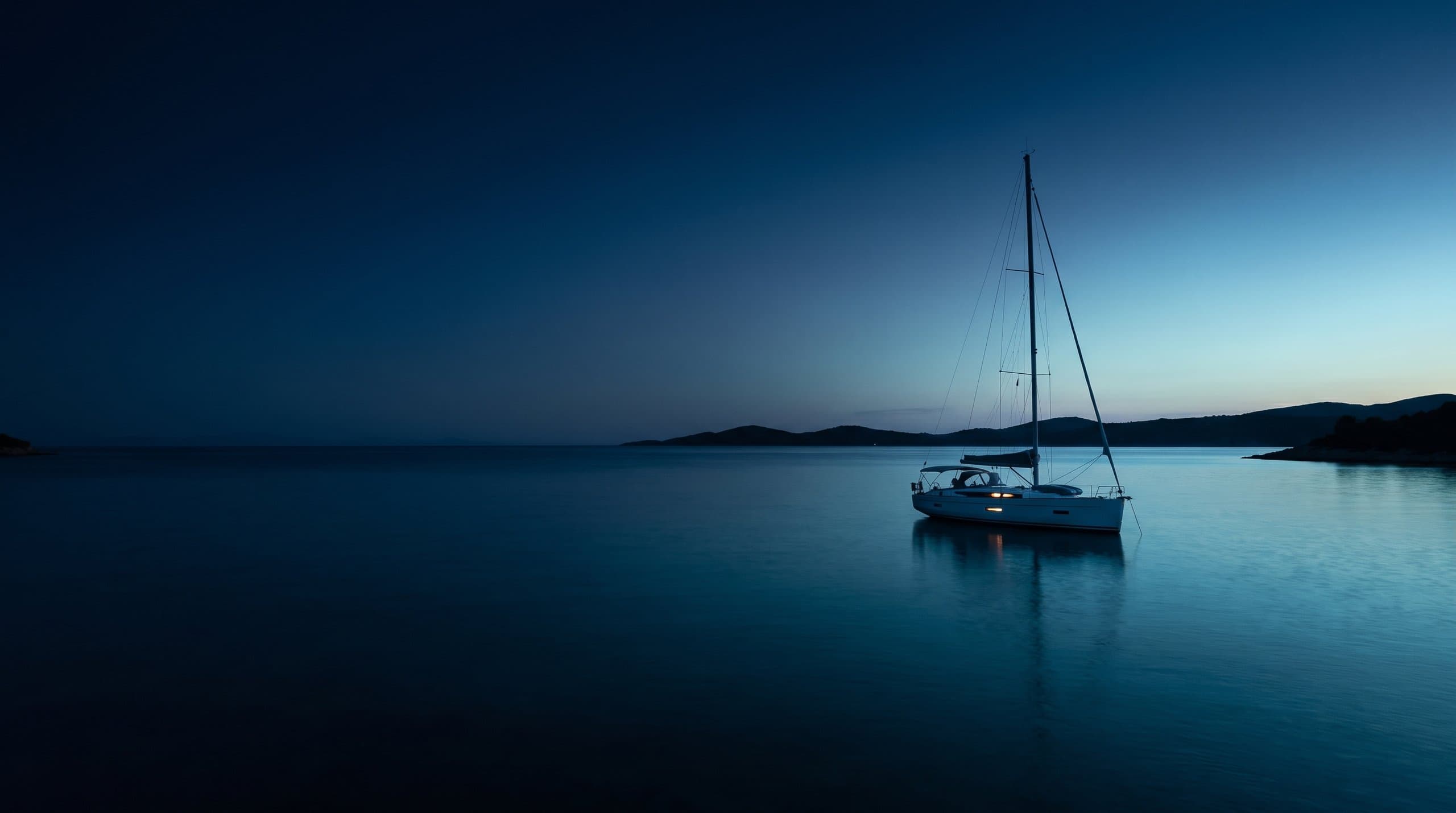 Un armatore consegna cime e chiavi a un noleggiatore sulla banchina di una marina adriatica al sole, con una barca a vela di 12 metri alle spalle.